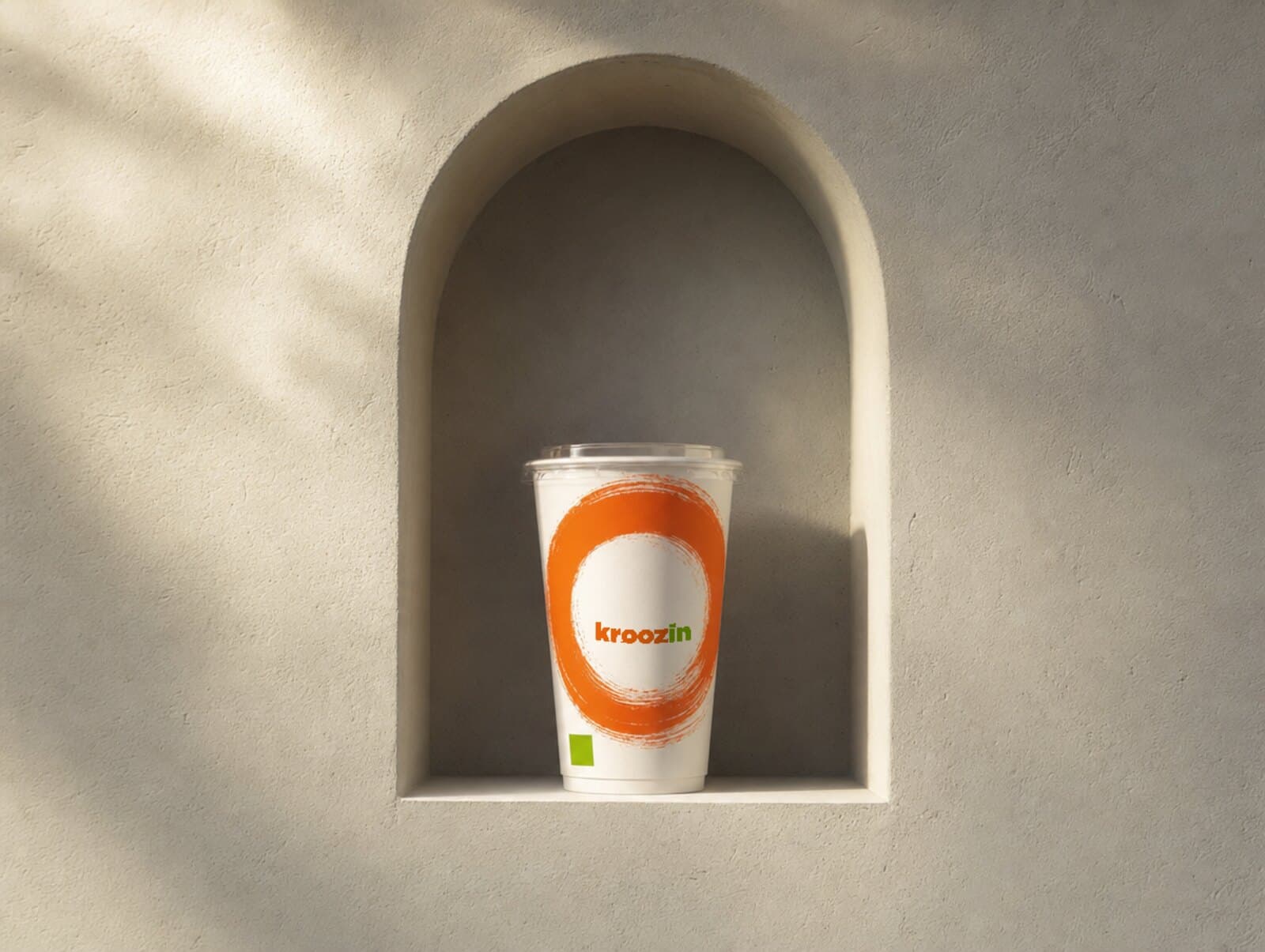 A Kroozin cup in a lit wall niche.