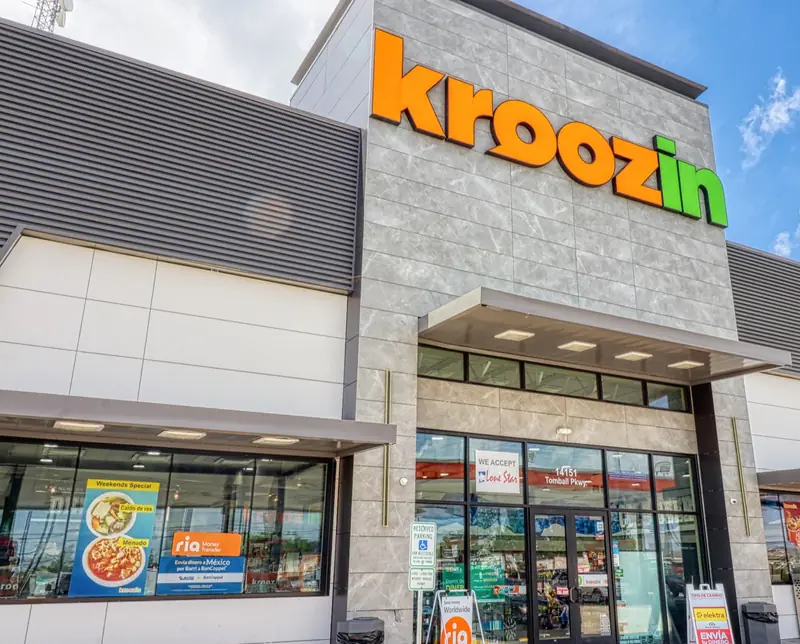 Kroozin store front on Tomball Pkwy, Houston, with window posters for caldo de res and menudo