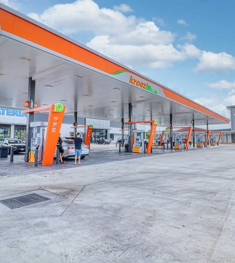 Kroozin Clay fuel canopy with orange Kroozin branding under a blue sky, 19533 Clay Rd, Katy